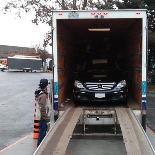 Movers manoeuvring an oversize item through a Whistler home entryway