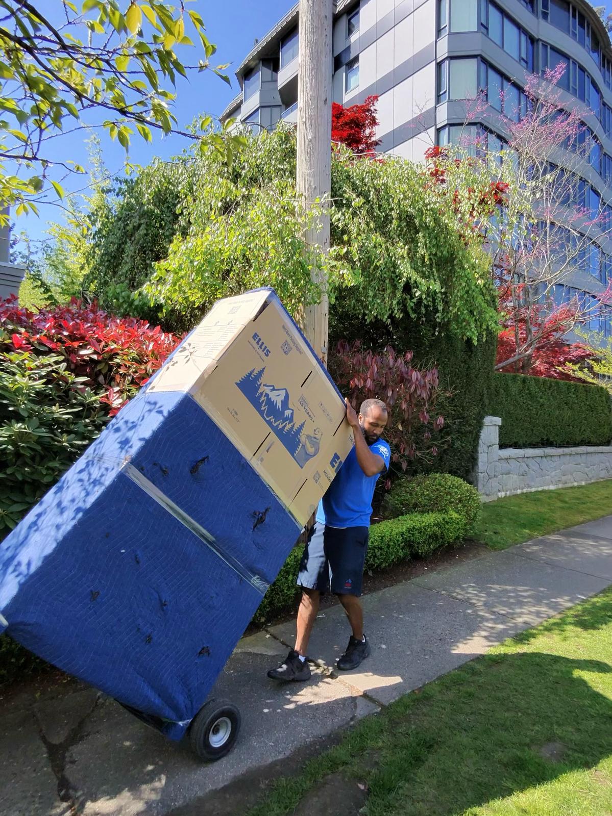 Movers wheeling boxes through a Whistler condo building hallway